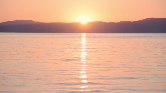 Landscape sunset view reflected on Lake Bracciano, Italy