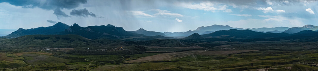 Incredibly beautiful landscape view from the mountain to the valley before a thunderstorm in spring.