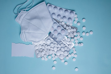 Protective mask on a background of white pills