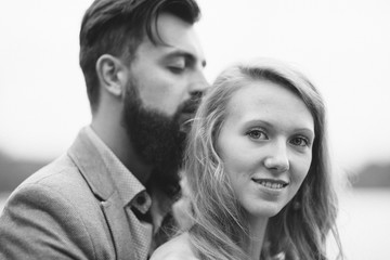 Close up portrait of happy couple. Curley smart girl and bearded handsome man