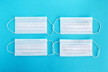 Ear-loop face masks three ply. Safety masks on blue background.