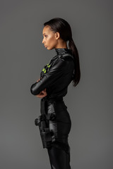 Naklejka premium side view of serious attractive futuristic african american woman isolated on grey