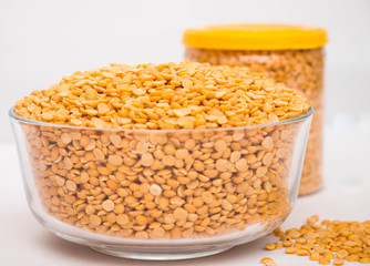 Toor dal or split yellow lentils in a glass bowl isolated