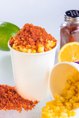 Boiled corn kernels in foam cup side view isolated on white background.