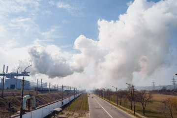 Bad ecology concept. Smoke from the pipes of the goes to the city .Factory,  metallurgical production plant full cycle. Environmental issues - harmful emissions, air pollution in industrial zone