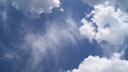 fluffy white clouds in the blue sky