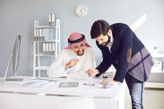 Arab And European Businessman Working Confident In A White Office.