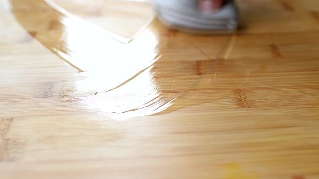 Applying wood care oil on a food cutting board.