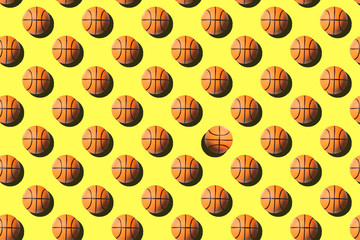 Basketball balls seamless pattern on bright yellow background.