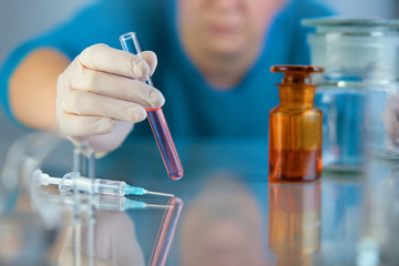 Scientist hand holding test tubes, laboratory research. viruses, coronavirus