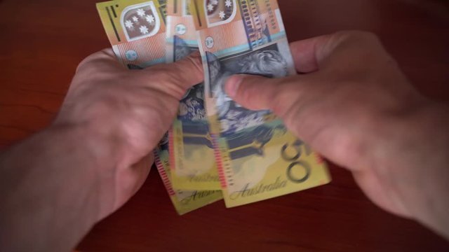 Hands Counting 50 Note Australian Dollars. Plastic Money