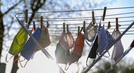 Hygienic mask hanging on the rack outdoor after being washed for cleanness and hygiene during...