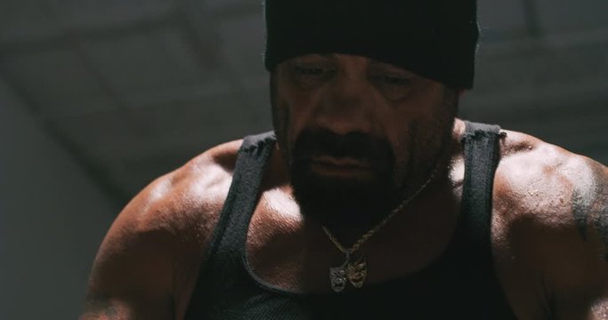 Close up of fighters face as he wraps his hands.