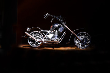 Fototapeta na wymiar motorcycle on a black background under lighting