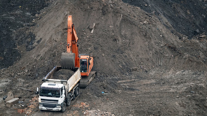 Tractors and excavators work on the construction of the foundation zero cycle