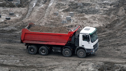 Tractors and excavators work on the construction of the foundation zero cycle