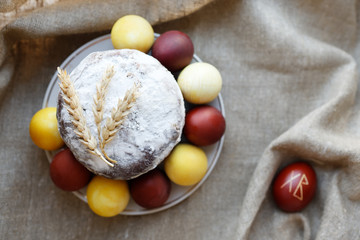 Easter cake and eggs on burlap. Selective focus, top view.