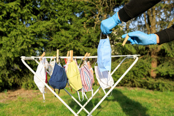 Hygienic mask hanging on the rack outdoor after being washed for cleanness and hygiene during...