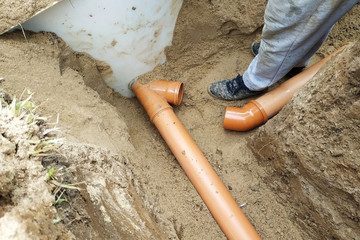 Supply of a sewer pipe to a sump by a master locksmith in the countryside. 2019