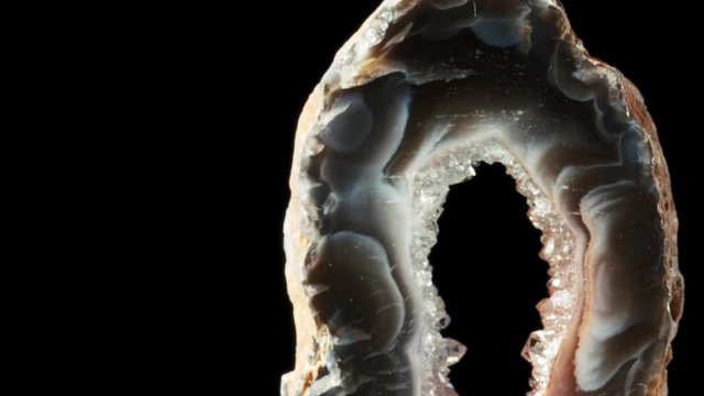 Agate with quartz. Agate rotates around its axis on a black background.