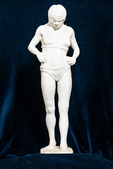 Fototapeta na wymiar Gypsum sculpture of an unknown girl. The girl stands