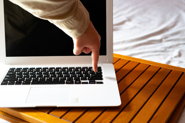 Hand pressing a key on the computer.