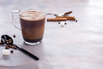Delicious and fragrant coffee with a glass cup of milk, sticks of fragrant cinnamon, coffee beans,...