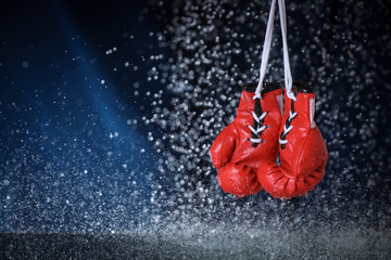Red boxing gloves on a water drops background.  Sport lifestyle. Motivation. Goal achievement. Protect yourself