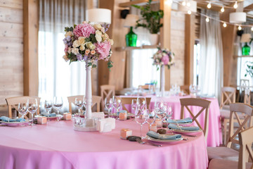 Wedding decor at the banquet. Wedding restaurant decorated with flowers. Luxury wedding table decoration. Special event table set up. Fresh flower decoration.