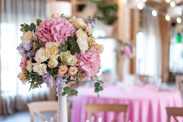 Wedding decor at the banquet. Wedding restaurant decorated with flowers. Luxury wedding table decoration. Special event table set up. Fresh flower decoration.