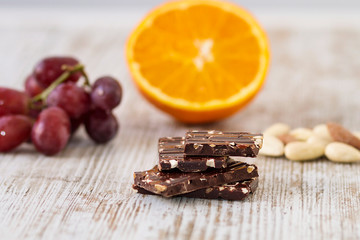 Pieces of dark chocolate with almonds and fruits