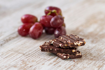 Pieces of dark chocolate with almonds and fruits