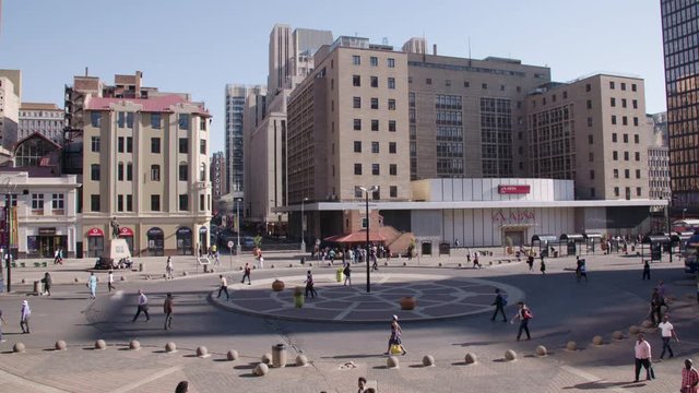 Wide shot of Gandhi Square in Johannesburg on a busy weekday. 