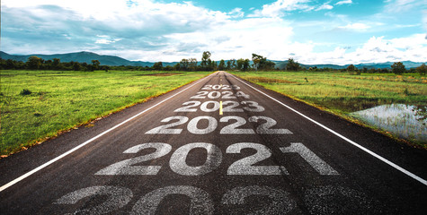 2020-2025 written on highway road in the middle of empty asphalt road at golden sunset and beautiful blue sky. Concept for vision 2020-2025.