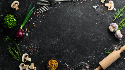 Obraz na płótnie Canvas Food background. Spices and herbs on black stone background. Top view.