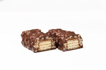 sliced chocolate bar with dark brown chocolate with nuts on a white background.