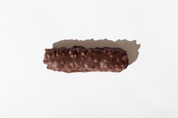 chocolate bar with dark brown chocolate with nuts on a white background.