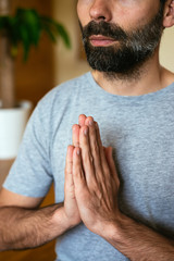 Young man doing yoga at home