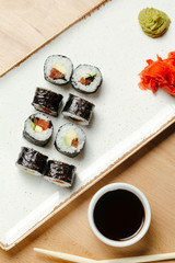 Japanese sushi roll set on delivery in quarantine. Red dragon. Rice, nori, tempura shrimp, tabasco sauce, cucumber, fresh salmon, salmon caviar.