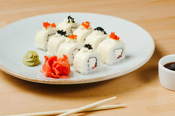 Sushi set roll three cheeses. Rice, nori, toast cheese, cream cheese, feta cheese. Online delivery on quarantine. Concept of healthy organic food.