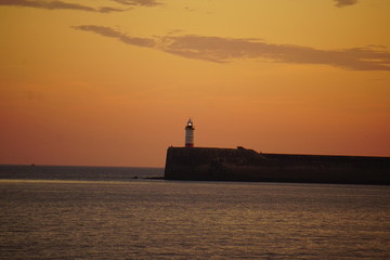 Fototapeta premium Newhaven lighthouse, sunset, Seaford, UK, July 2019