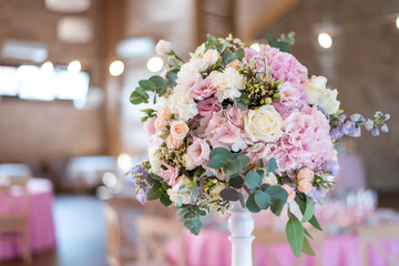 Close up of pink and lilac wedding bouquet. Wedding decoration. Bride's wedding bouquet. Wedding decor at the banquet. Wedding restaurant decorated with flowers. Luxury wedding table decoration. 