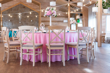 Wedding decor at the banquet. Wedding restaurant decorated with flowers. Luxury wedding table decoration. Special event table set up. Fresh flower decoration.