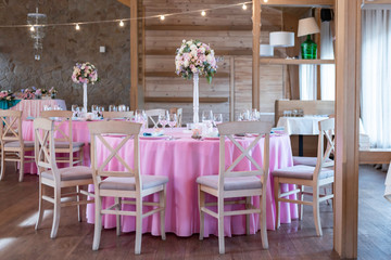 Wedding decor at the banquet. Wedding restaurant decorated with flowers. Luxury wedding table decoration. Special event table set up. Fresh flower decoration.