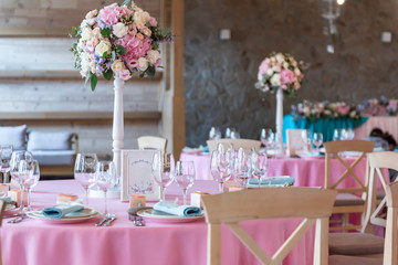 Wedding decor at the banquet. Wedding restaurant decorated with flowers. Luxury wedding table decoration. Special event table set up. Fresh flower decoration.