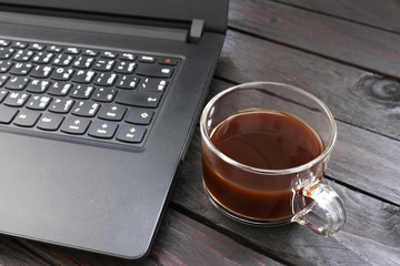ฺBlack coffee Put aside laptop on a wooden table break during working hours in office