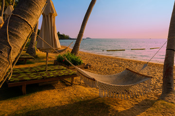 Fototapeta na wymiar Beautiful beach with palms at sunset in Phu Quoc, Vietnam