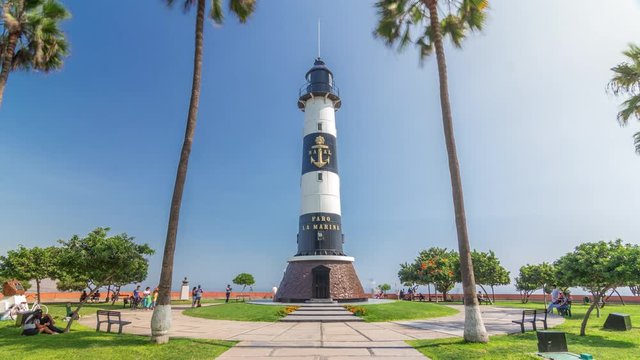 Lighthouse monument in the Park of Love of Miraflores timelapse hyperlapse. Green lawn with flowers and palms. Coastline park in nice sunny day. Lima, Peru