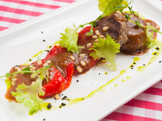 two steaks with pepper and pine nuts