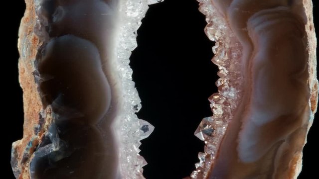 Agate with quartz. Agate rotates around its axis on a black background.
